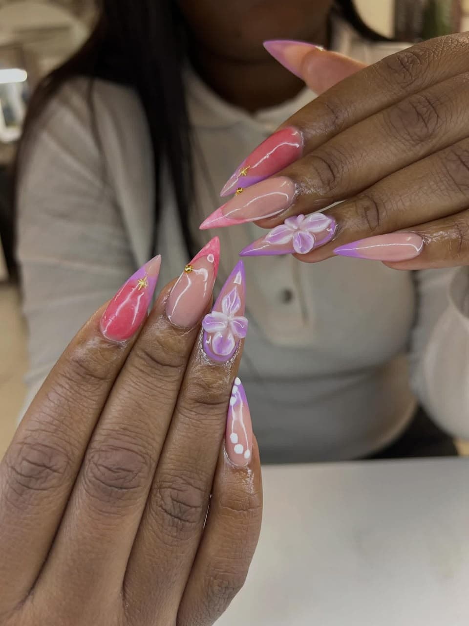 Stiletto nails in pink and lilac with 3D flowers and gold star accents