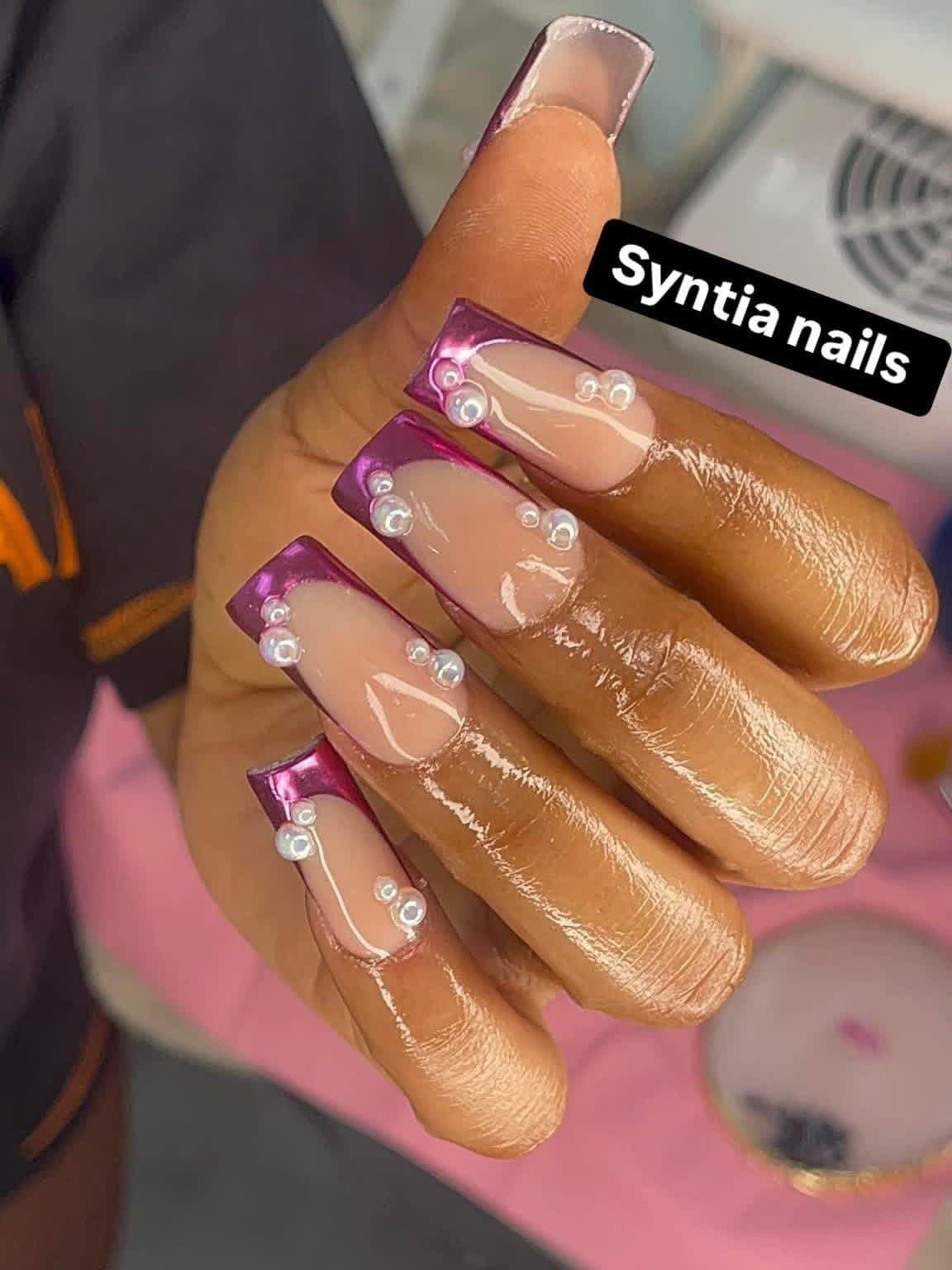 Long square nails with metallic magenta chrome French tips and pearl accents